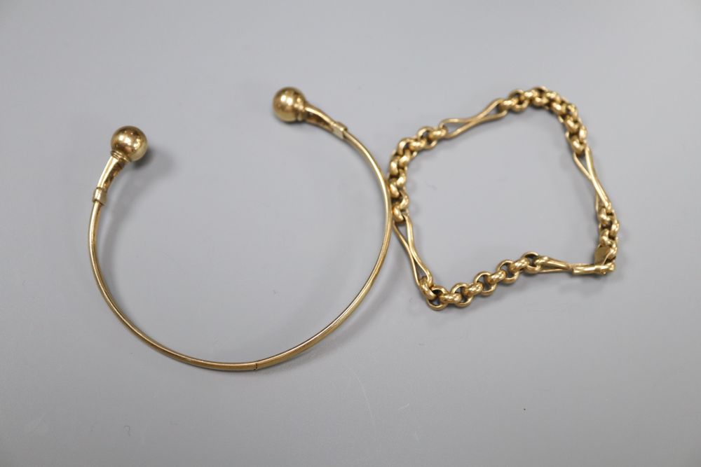 A yellow metal bangle, a yellow metal small chain bracelet and a yellow metal gem set cobra ring,
